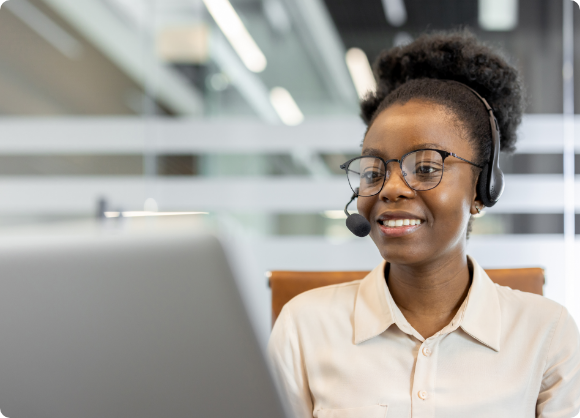 African-American woman wearing headset working on her laptop